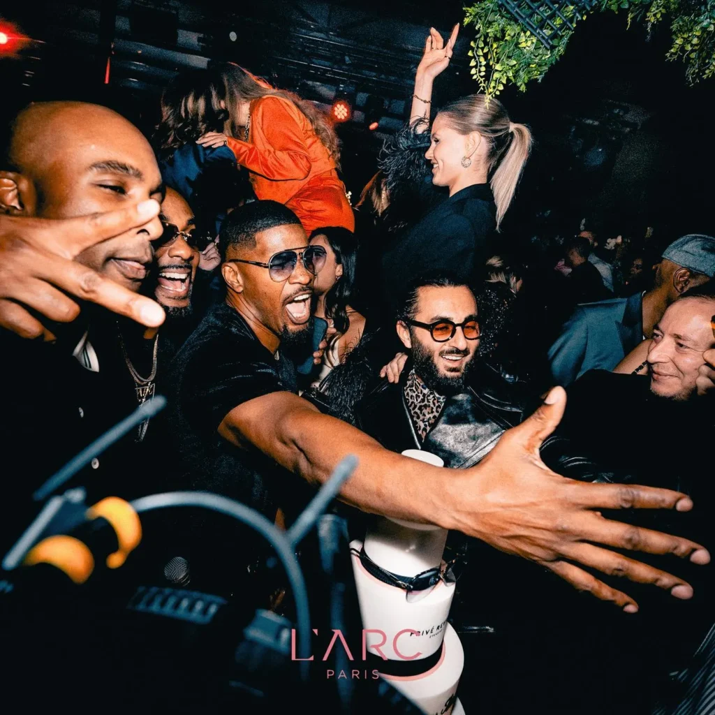 Crowd enjoying the vibrant atmosphere at L'Arc Paris