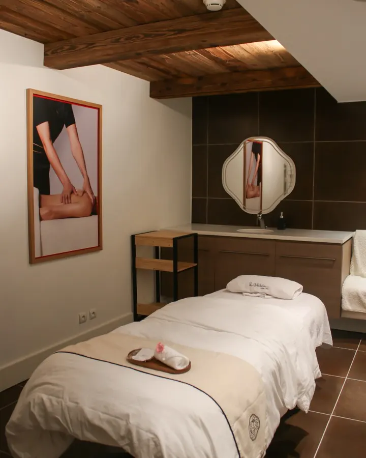 Cozy bedroom with alpine decor at Le Chabichou Courchevel