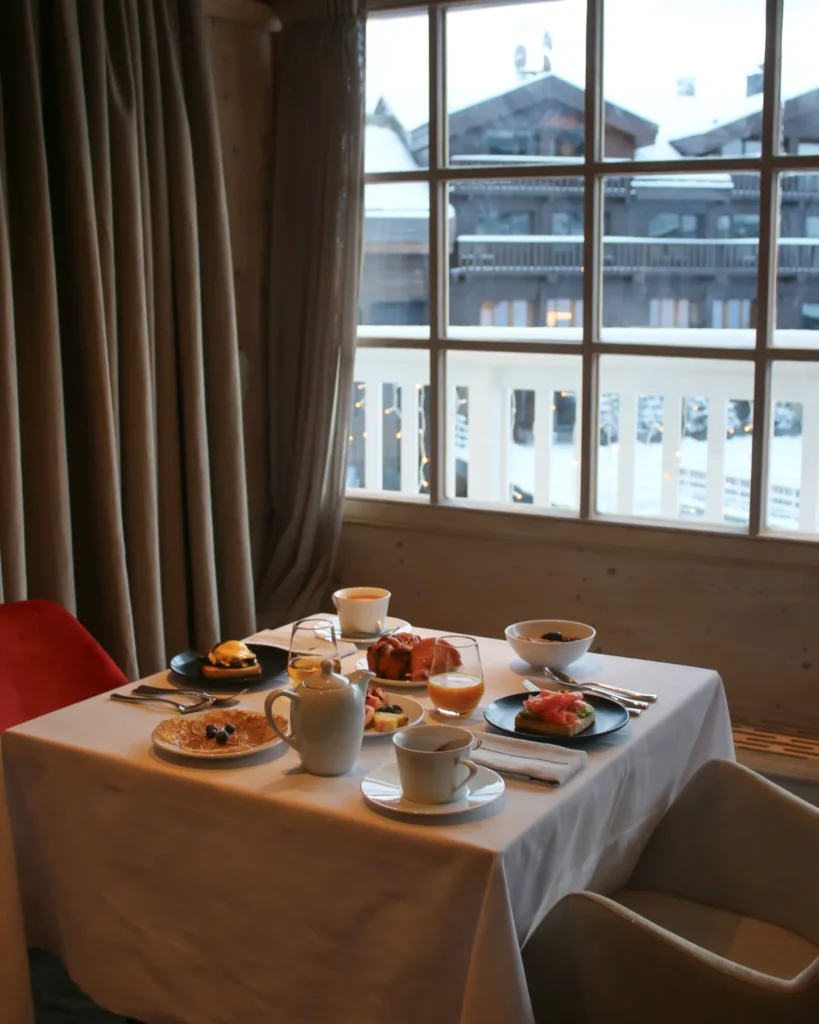 Elegant table setting beside a panoramic window at Le Chabichou Courchevel