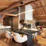 Cozy alpine living room with wood-paneled ceiling at Le Chabichou Courchevel