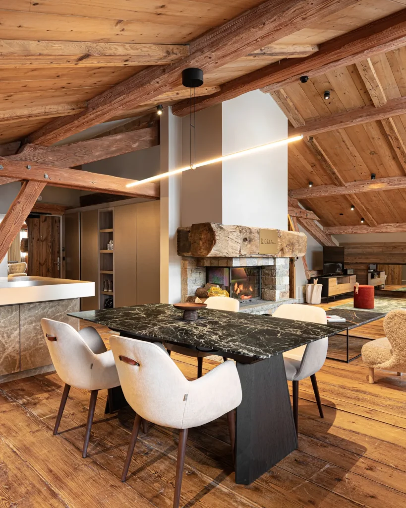 Cozy alpine living room with wood-paneled ceiling at Le Chabichou Courchevel