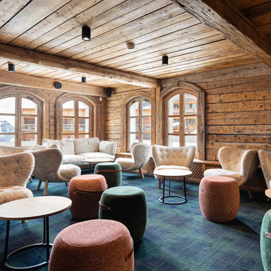 Wood-paneled lounge with comfortable seating at Le Chabichou Courchevel