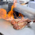 Food being prepared over an open fire at Le Chabichou Courchevel