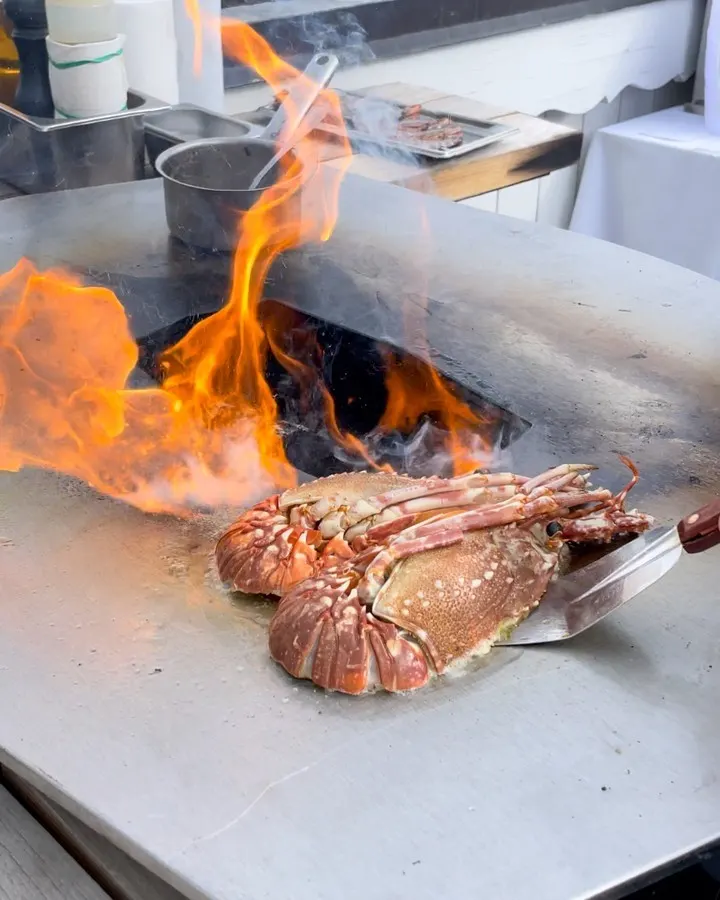 Food being prepared over an open fire at Le Chabichou Courchevel