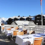 Outdoor dining terrace overlooking the snowy mountains at Le Chabichou Courchevel