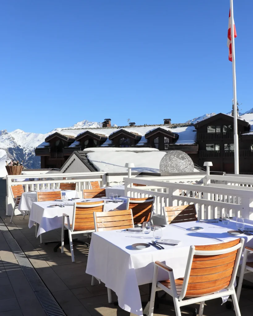 Outdoor dining terrace overlooking the snowy mountains at Le Chabichou Courchevel