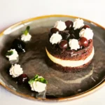Chocolate dessert with cream and berries at Le Genepi Courchevel