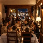 Guests dining inside the warm alpine dining room at Le Genepi Courchevel