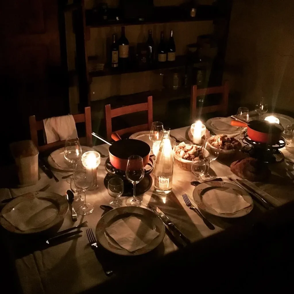 Candlelit dinner table set inside Le Genepi Courchevel
