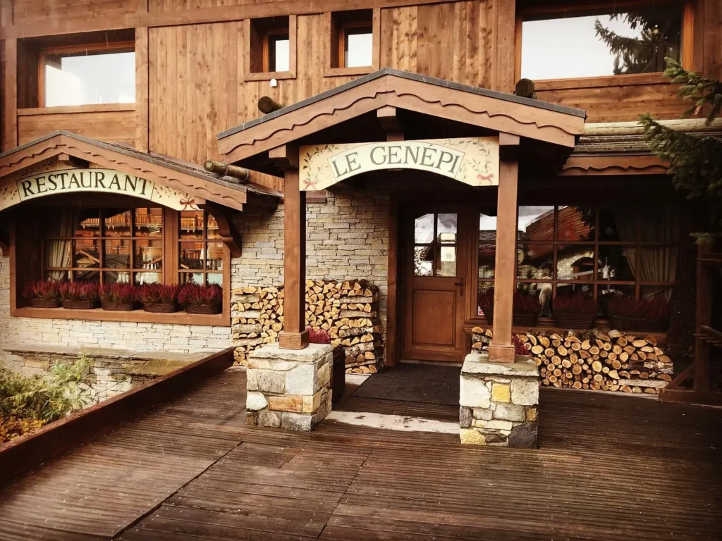 Wooden entrance and snow-covered exterior of Le Genepi Courchevel
