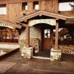 Wooden entrance and snow-covered exterior of Le Genepi Courchevel