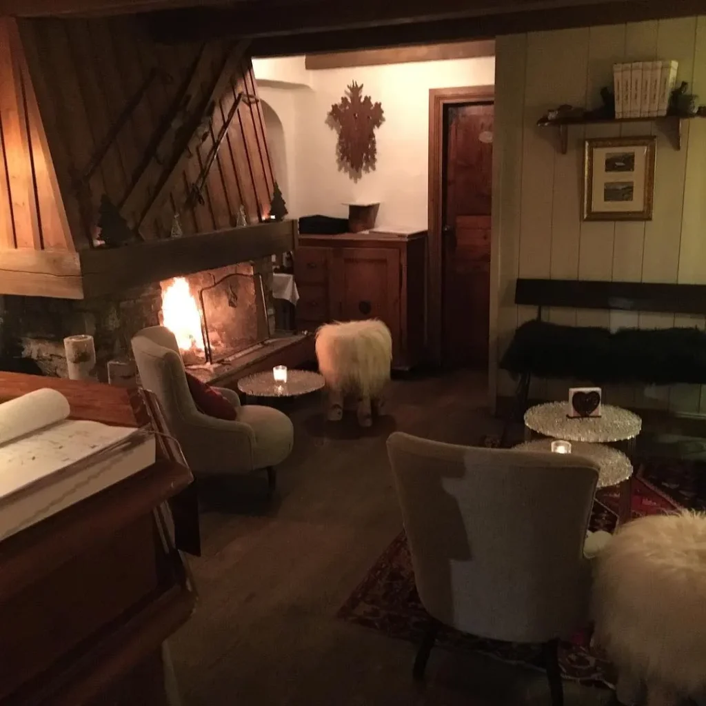 Cozy lounge with fireplace and alpine decor at Le Genepi Courchevel