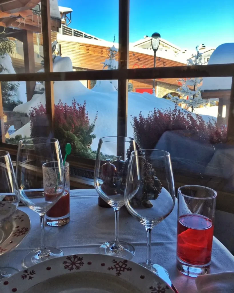 Elegant table setting beside the window at Le Genepi Courchevel