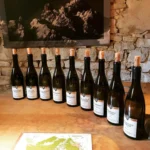 Wine bottles displayed on a stone wall at Le Genepi Courchevel