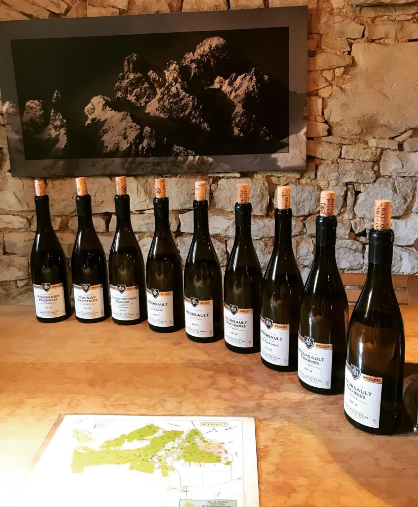 Wine bottles displayed on a stone wall at Le Genepi Courchevel
