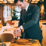 Chef preparing a dish at Le Relais Plaza in Paris