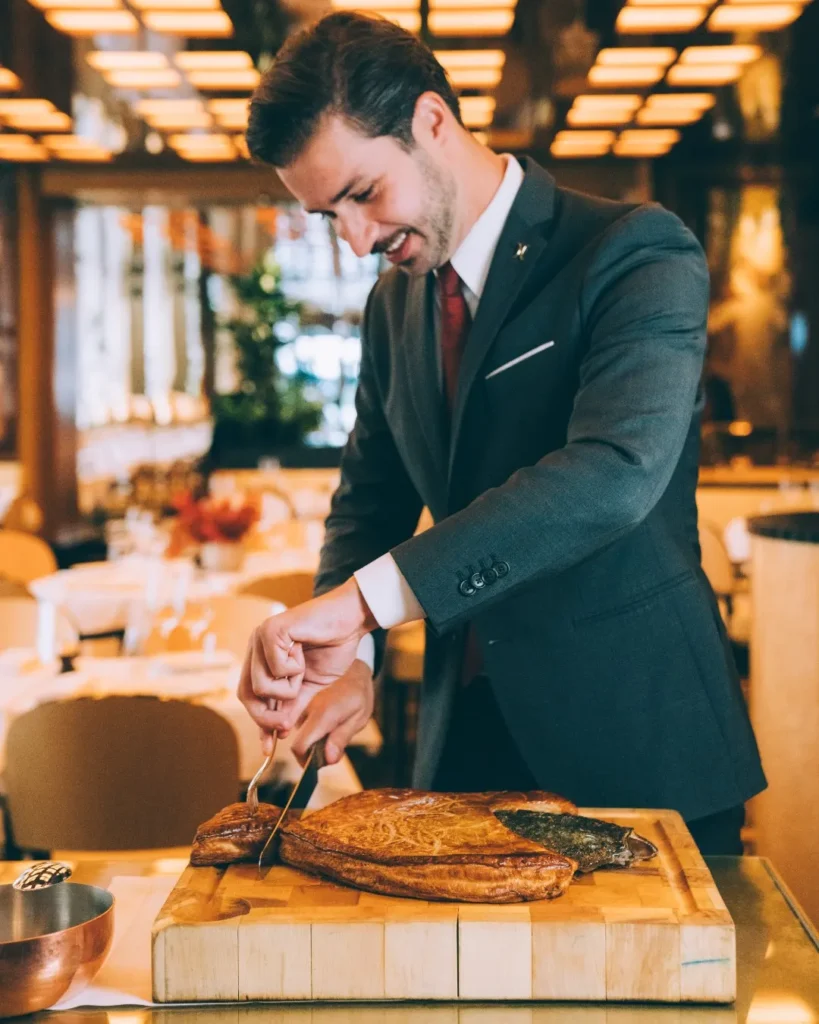 Chef preparing a dish at Le Relais Plaza in Paris