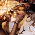 Guests enjoying drinks and dishes at Le Relais Plaza in Paris