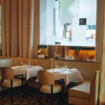 Elegant dining area with large windows at Le Relais Plaza in Paris