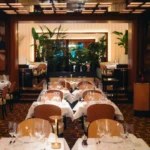 Elegant dining room with wood details at Le Relais Plaza in Paris