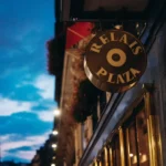 Le Relais Plaza sign against the Parisian streetscape
