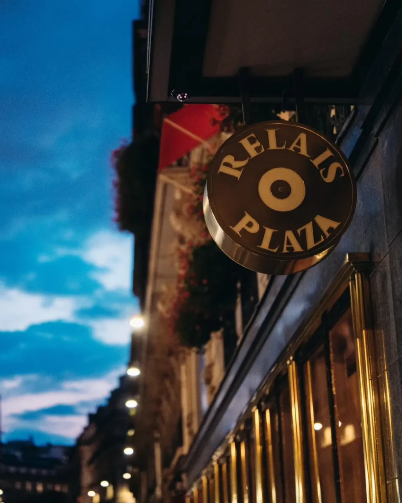 Le Relais Plaza sign against the Parisian streetscape