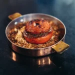Gourmet dish served at Le Relais Plaza in Paris