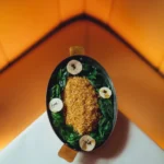 Artfully presented gourmet dish at Le Relais Plaza in Paris