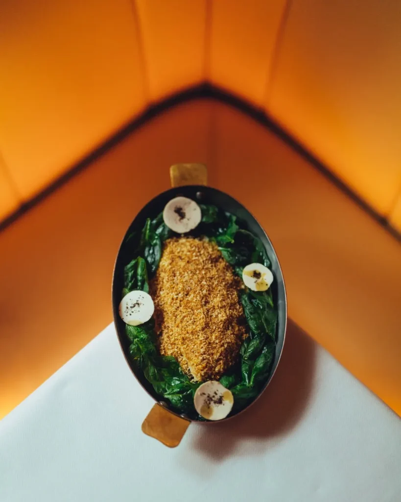 Artfully presented gourmet dish at Le Relais Plaza in Paris