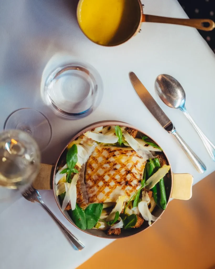 Gourmet plate served at Le Relais Plaza in Paris