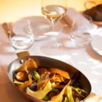 Gourmet seafood dish served at Le Relais Plaza in Paris