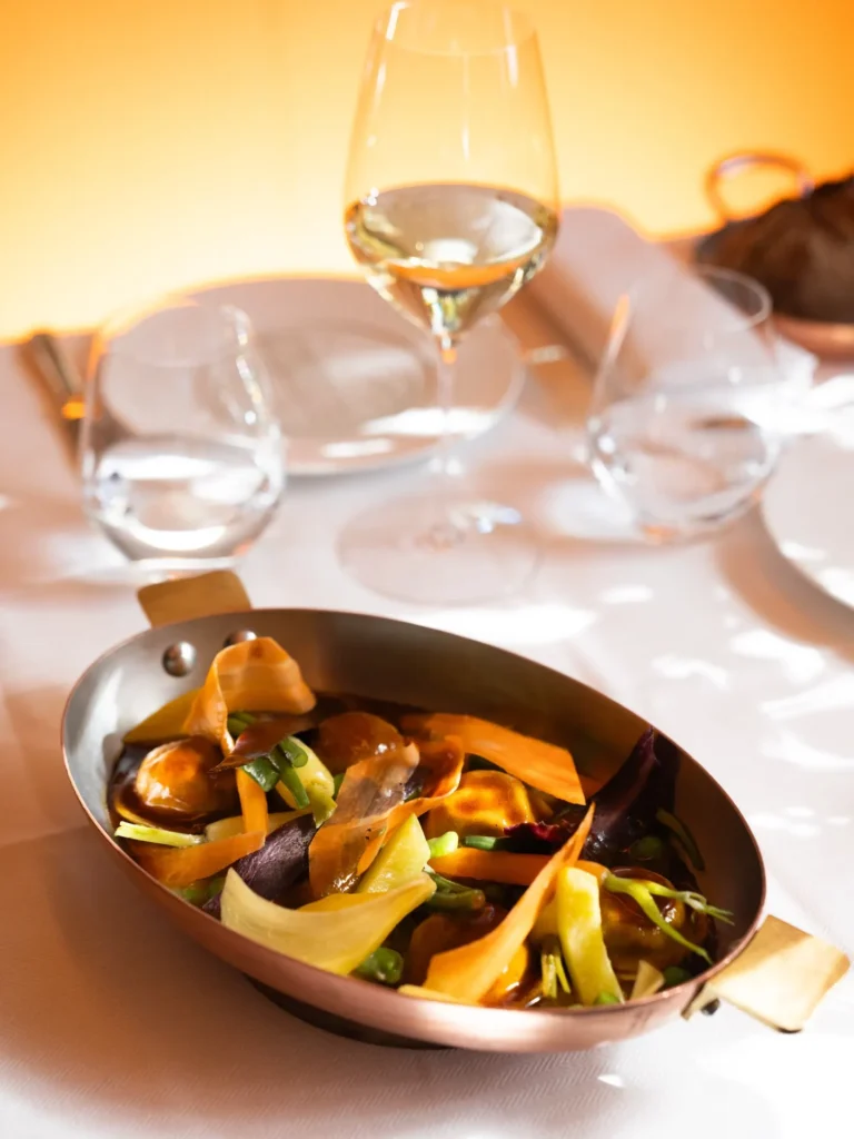 Gourmet seafood dish served at Le Relais Plaza in Paris