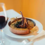Gourmet dish served at Le Relais Plaza in Paris