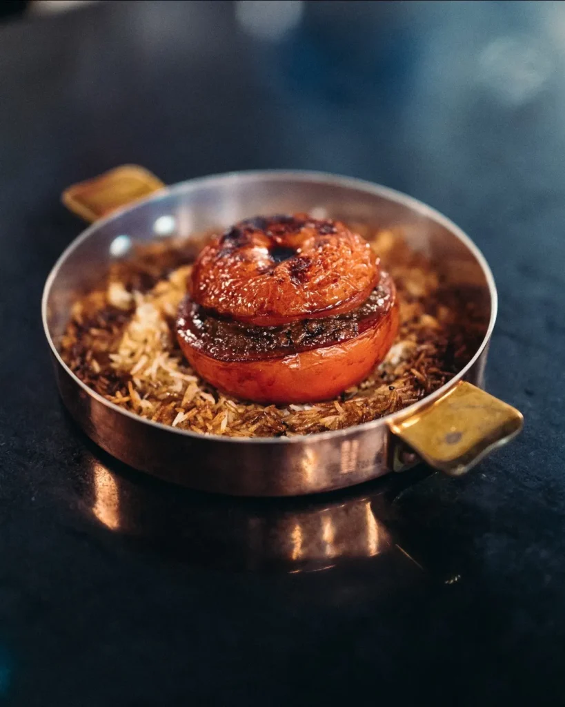Gourmet dish served at Le Relais Plaza in Paris