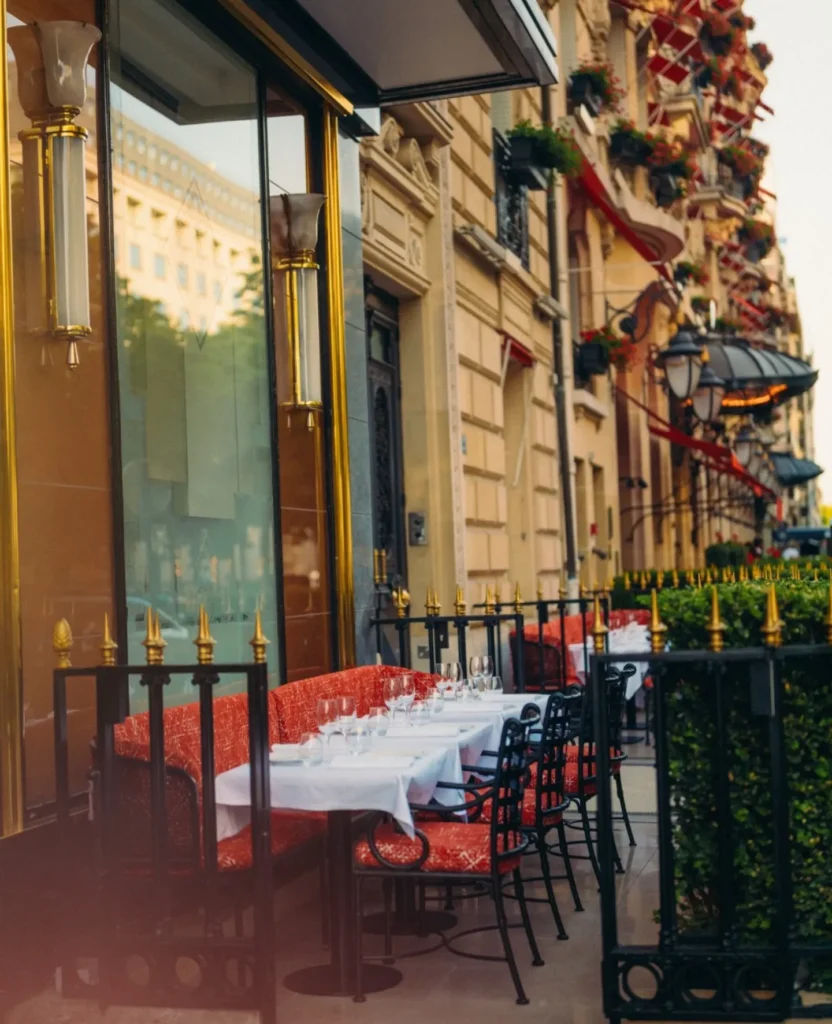 Outdoor restaurant terrace along a Parisian street at Le Relais Plaza