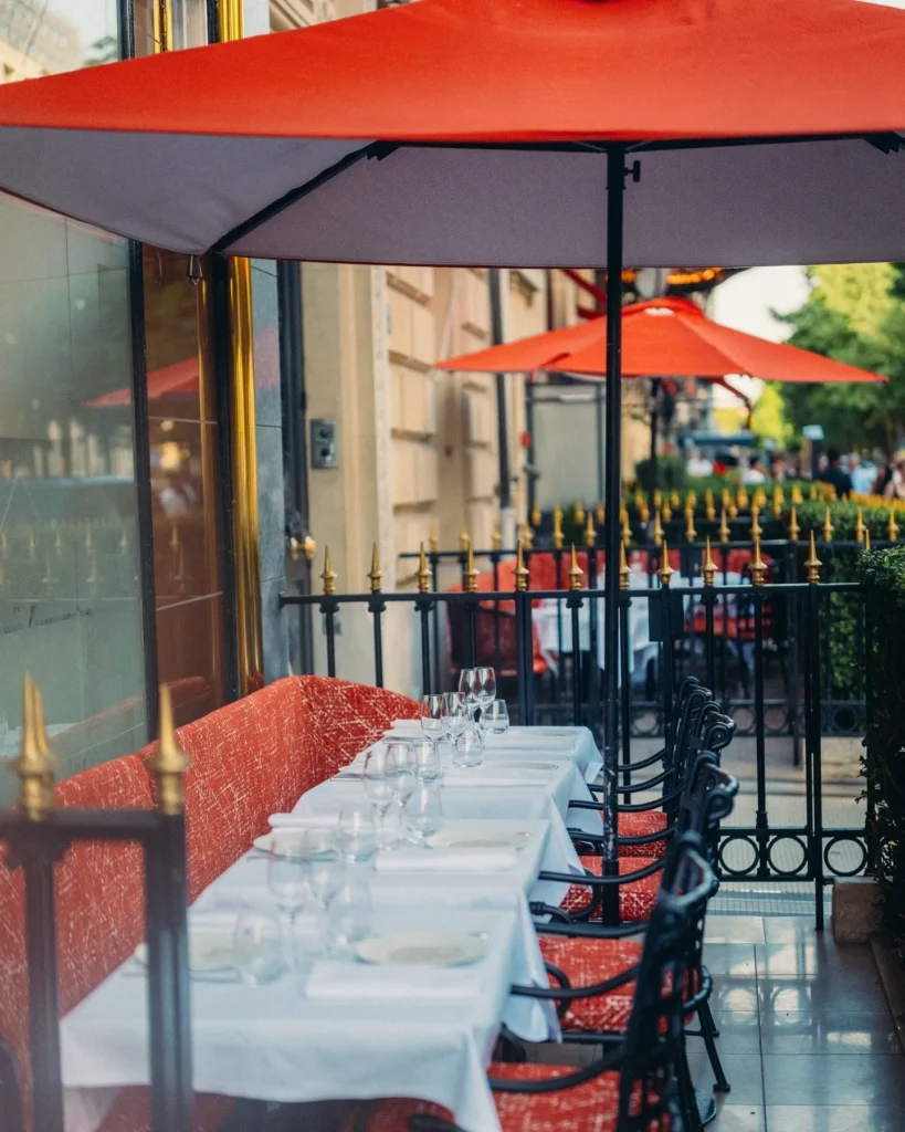 Outdoor terrace seating at Le Relais Plaza in Paris