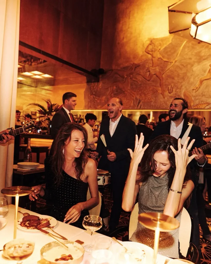 Guests celebrating together inside Le Relais Plaza in Paris
