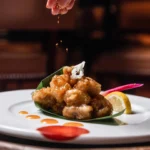 Gourmet dish served at Le Royal Monceau Paris