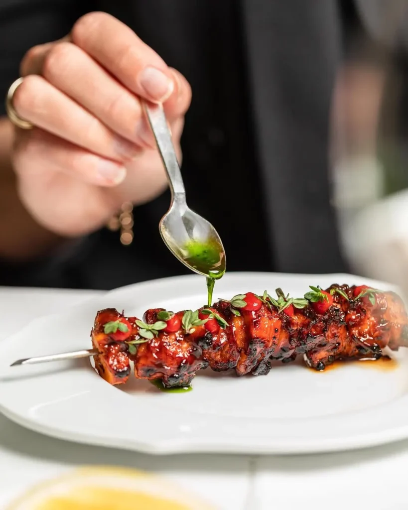 Chef plating a gourmet dish at Le Royal Monceau Paris