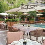 Poolside terrace with outdoor dining at Le Royal Monceau Paris