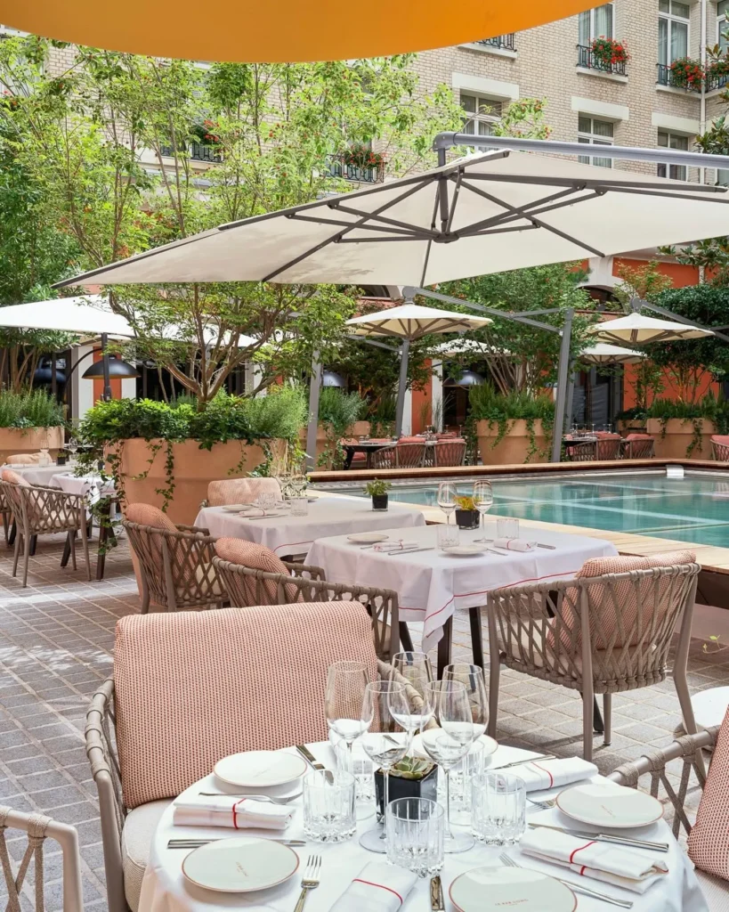 Poolside terrace with outdoor dining at Le Royal Monceau Paris