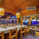 Wooden bar and dining area inside Le Tremplin Courchevel