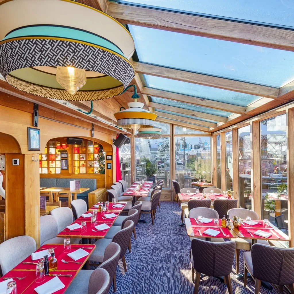 Bright conservatory-style dining area at Le Tremplin Courchevel