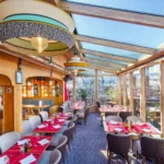 Bright conservatory-style dining area at Le Tremplin Courchevel