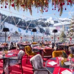 Covered outdoor dining terrace at Le Tremplin Courchevel with red table settings