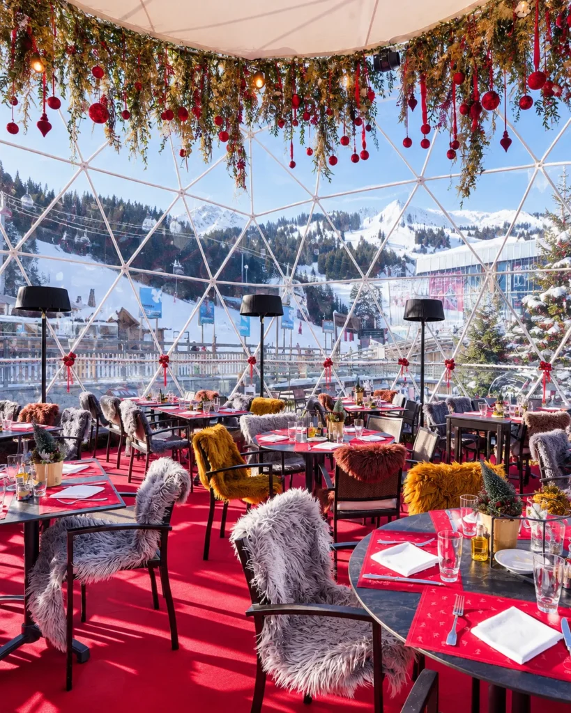 Covered outdoor dining terrace at Le Tremplin Courchevel with red table settings