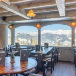 Bright dining area at Le Tremplin Courchevel with mountain views