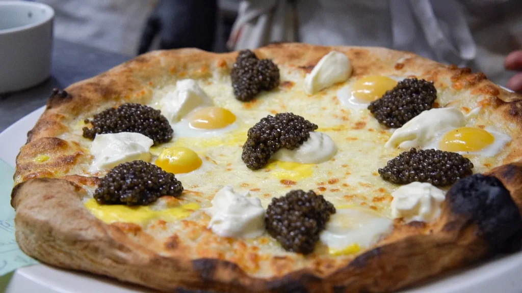 Pizza topped with cheese and black truffle at Le Tremplin Courchevel