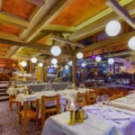 Warmly lit restaurant interior at Le Tremplin Courchevel