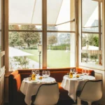 Bright dining room overlooking the gardens at Loulou Paris